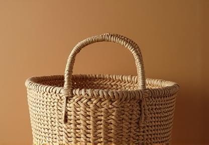 Finely crafted traditional woven basket made from natural fibers, highlighting texture and pattern